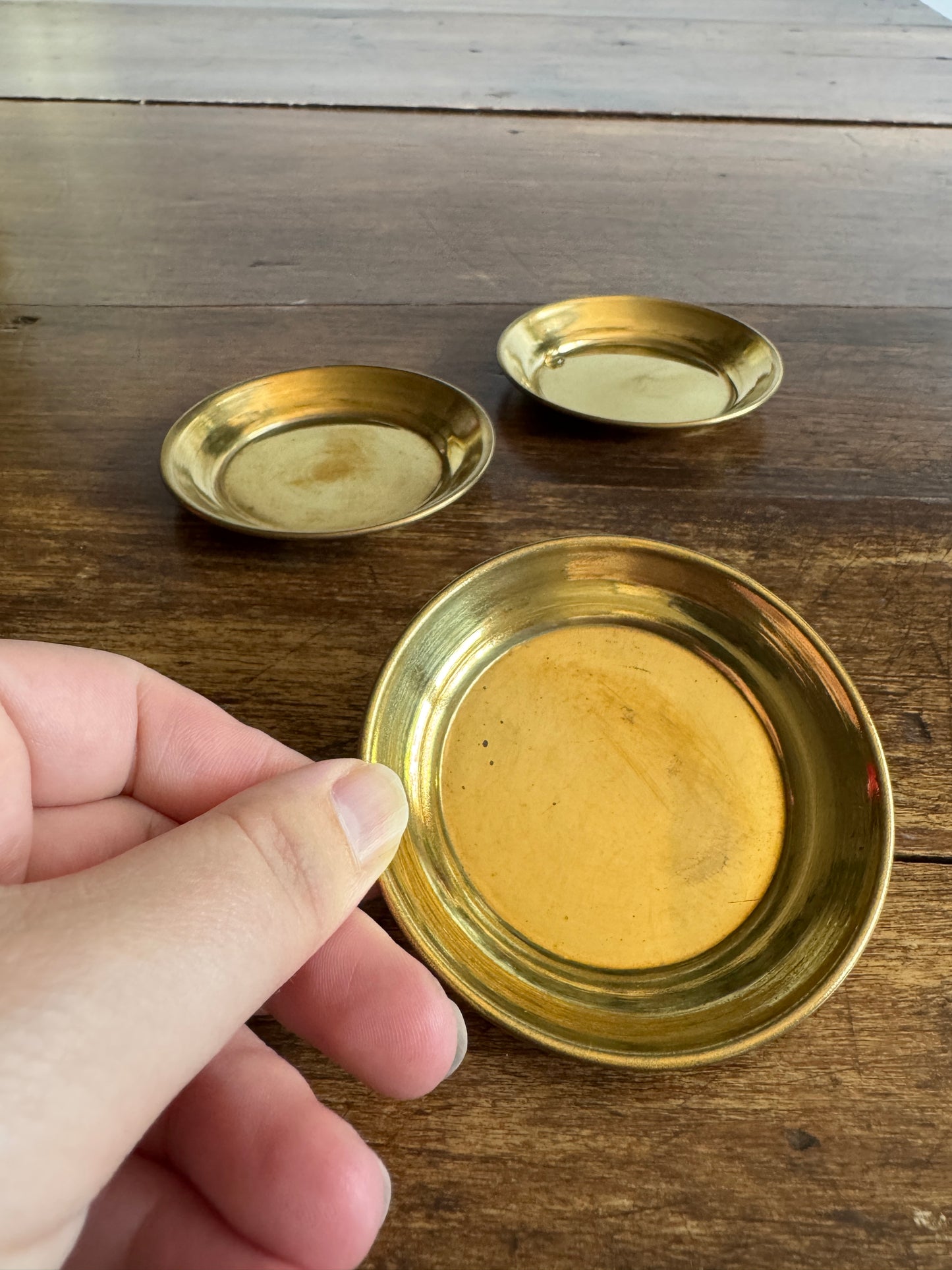 Three Small Brass Dishes with Simple Rolled Edge Design