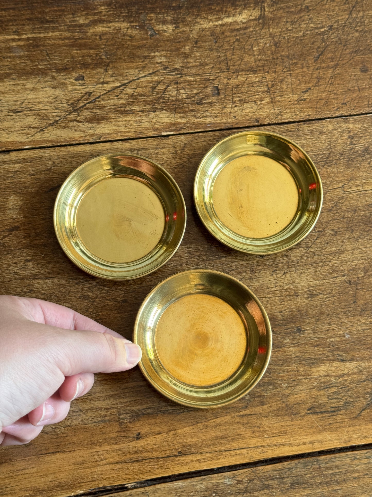 Three Small Brass Dishes with Simple Rolled Edge Design