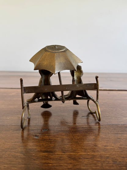 Vintage Brass Frogs Sitting on Bench Under Umbrella