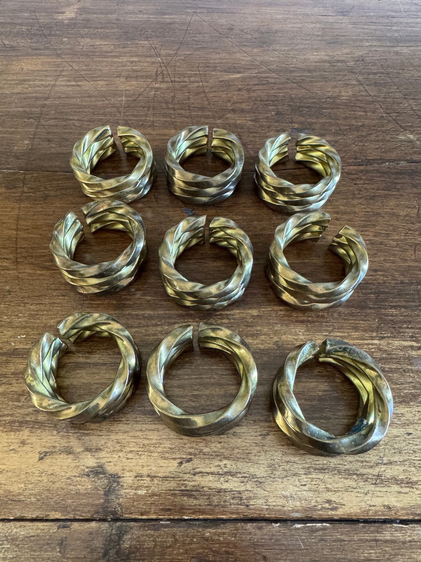 Set of Nine Brass Twisted Metal Napkin Rings