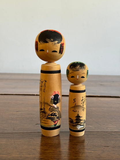Vintage Pair of Japanese Kokeshi Dolls with Scenic Bodies and Calligraphy
