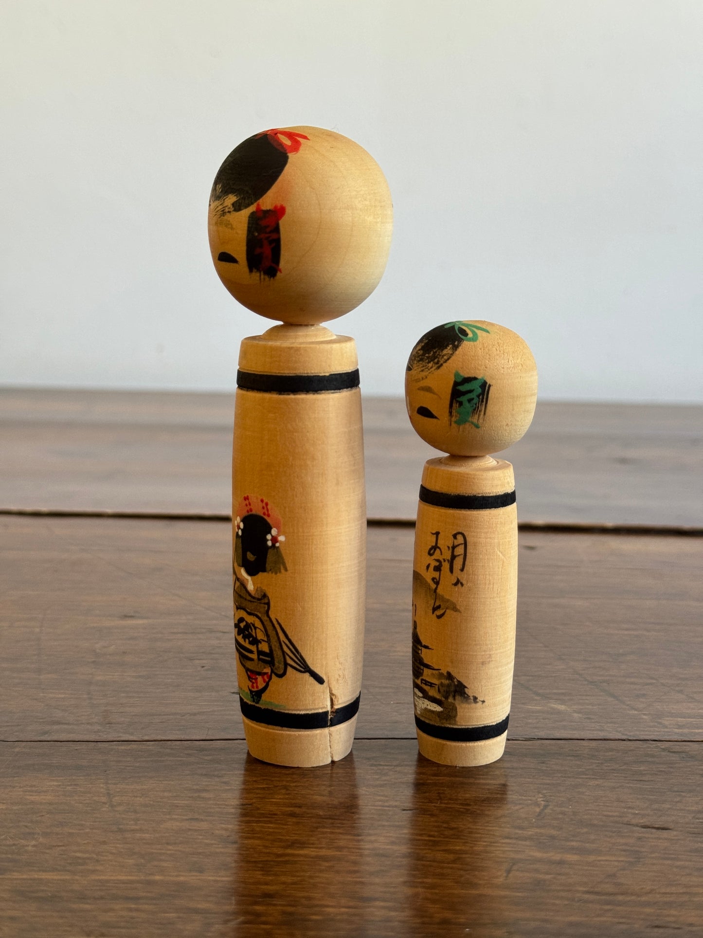 Vintage Pair of Japanese Kokeshi Dolls with Scenic Bodies and Calligraphy