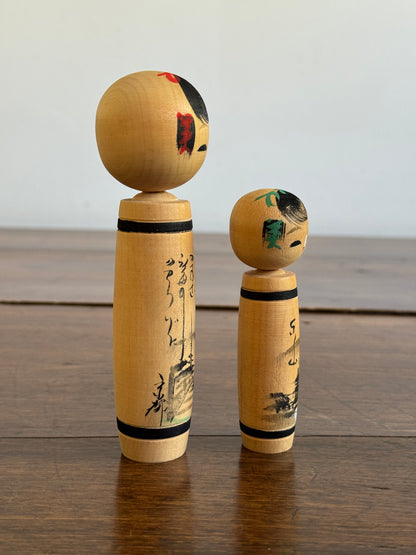 Vintage Pair of Japanese Kokeshi Dolls with Scenic Bodies and Calligraphy