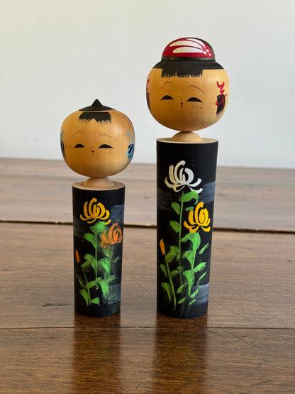 Two Japanese Dolls in Black with Hand Painted Florals