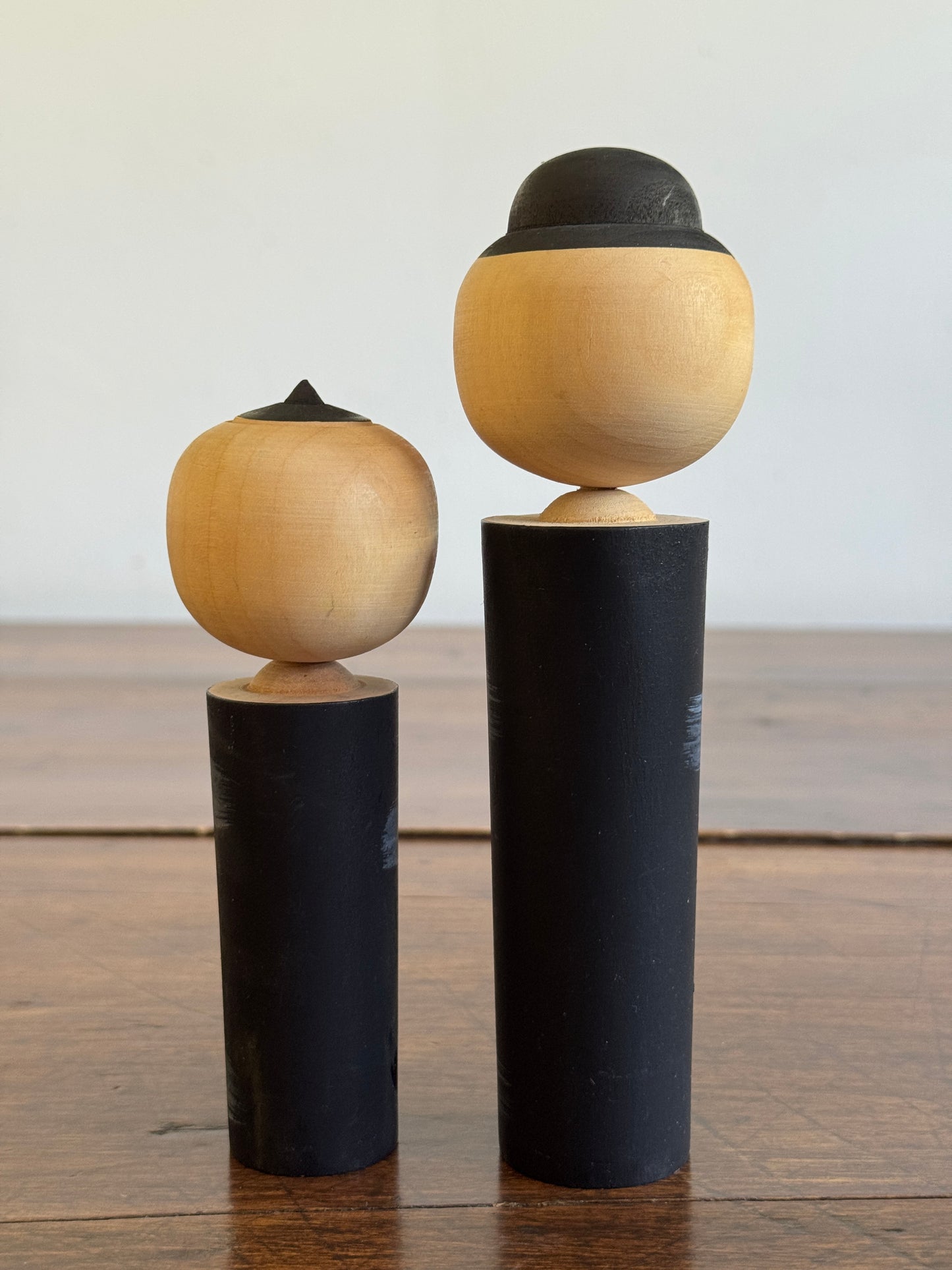 Two Japanese Dolls in Black with Hand Painted Florals