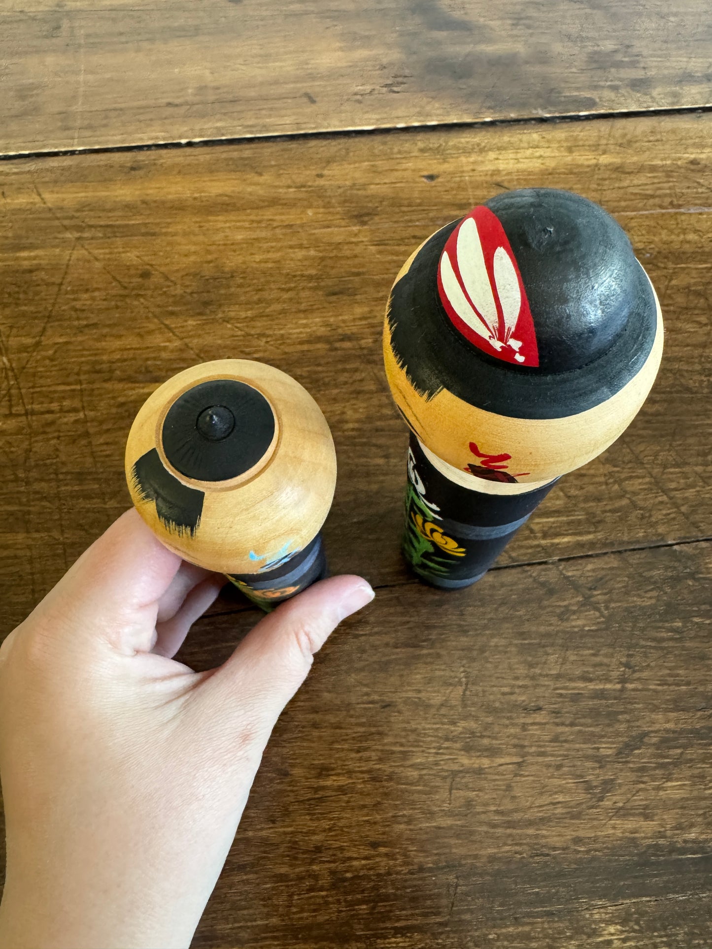 Two Japanese Dolls in Black with Hand Painted Florals