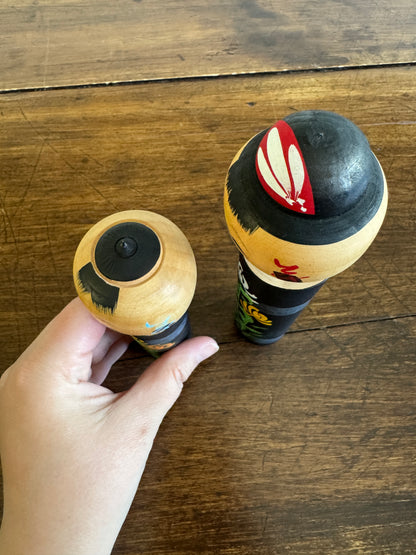 Two Japanese Dolls in Black with Hand Painted Florals