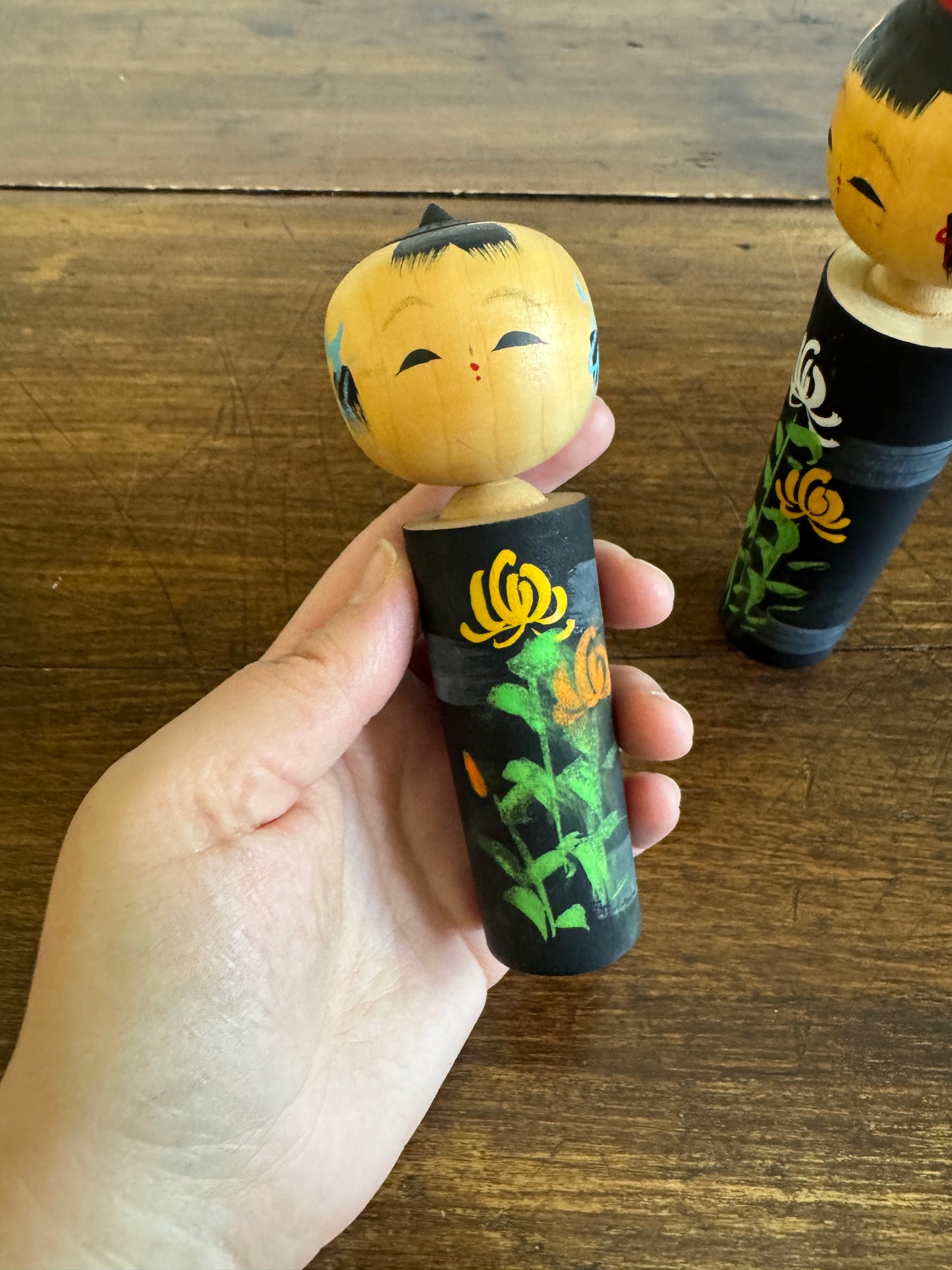 Two Japanese Dolls in Black with Hand Painted Florals