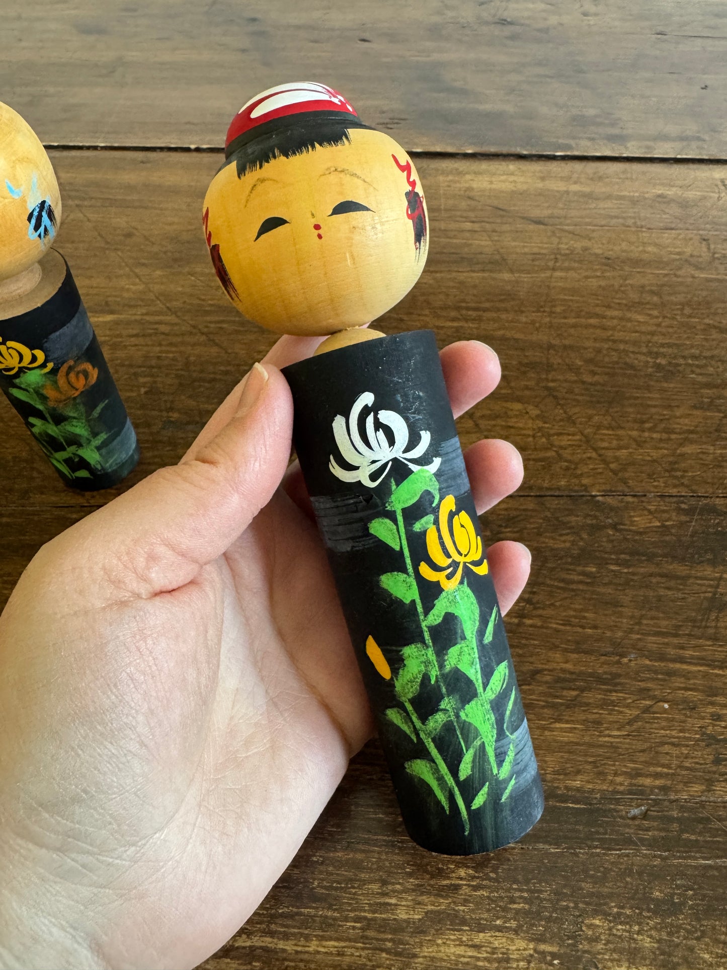 Two Japanese Dolls in Black with Hand Painted Florals